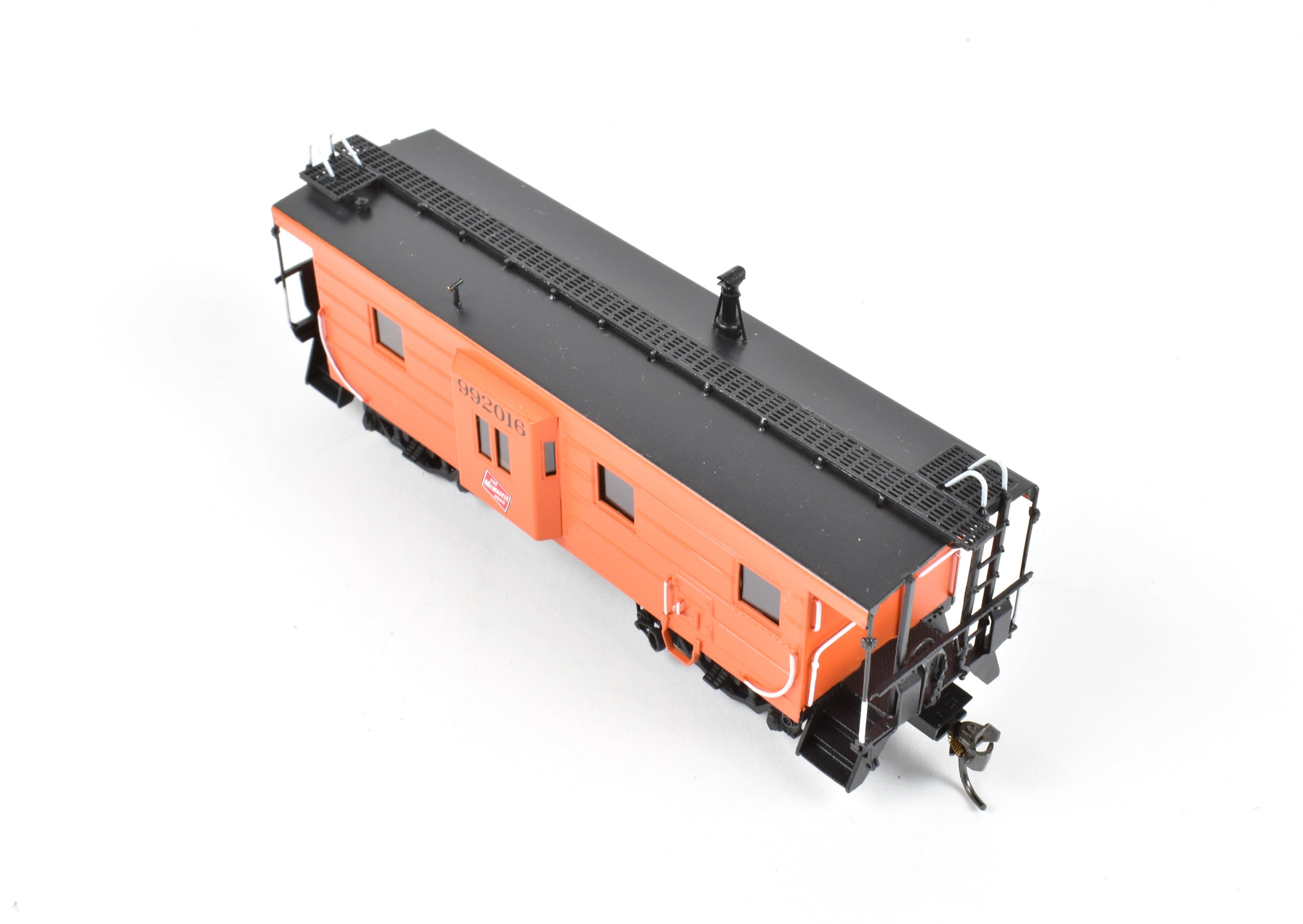 HO Scale Brass Model of Overland Models, Inc. Milwaukee Road Bay Window Caboose with Drop Center Trucks, CP No. 992016