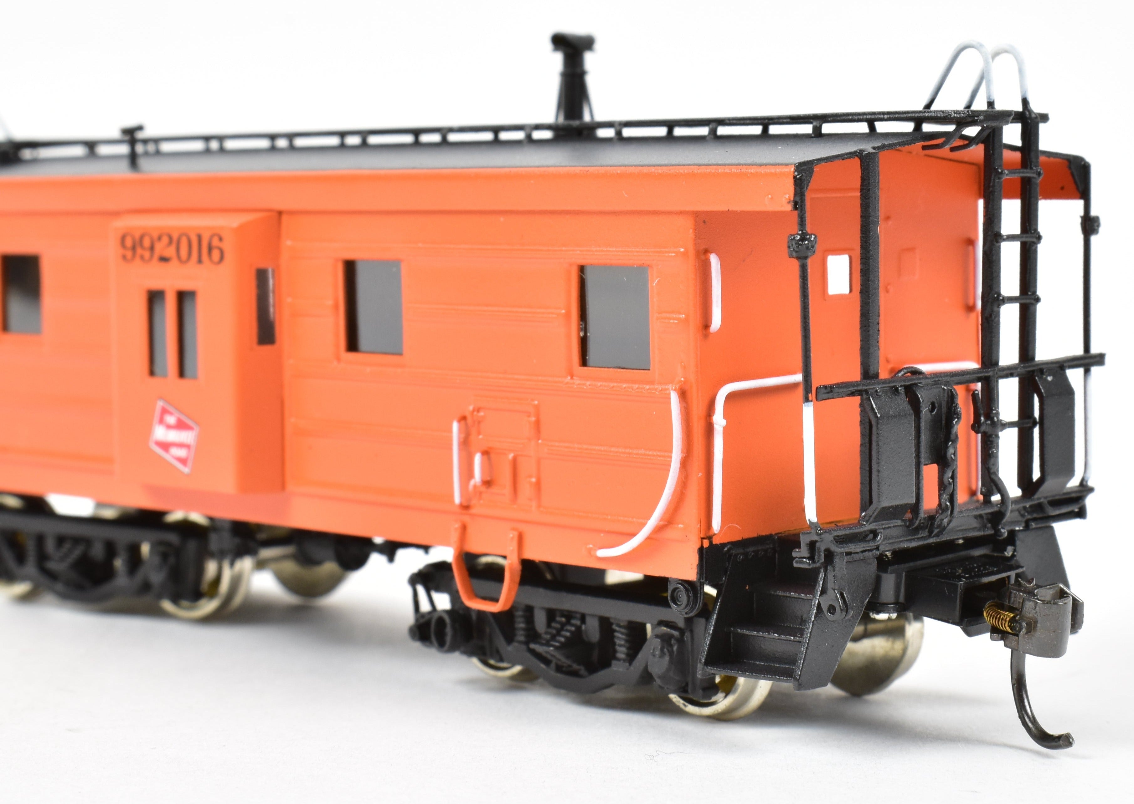 HO Scale Brass Model of Overland Models, Inc. Milwaukee Road Bay Window Caboose with Drop Center Trucks, CP No. 992016