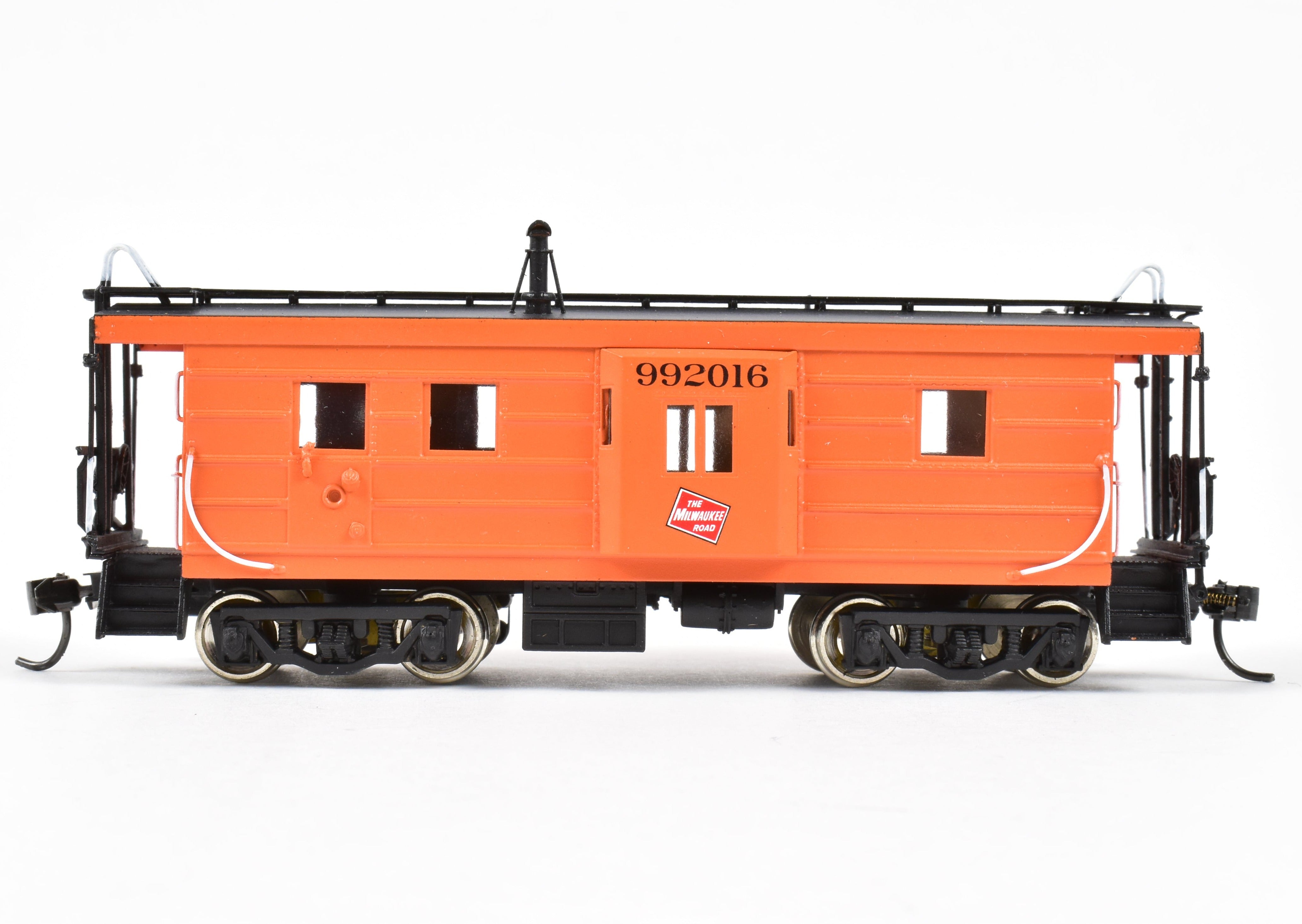 HO Scale Brass Model of Overland Models, Inc. Milwaukee Road Bay Window Caboose with Drop Center Trucks, CP No. 992016