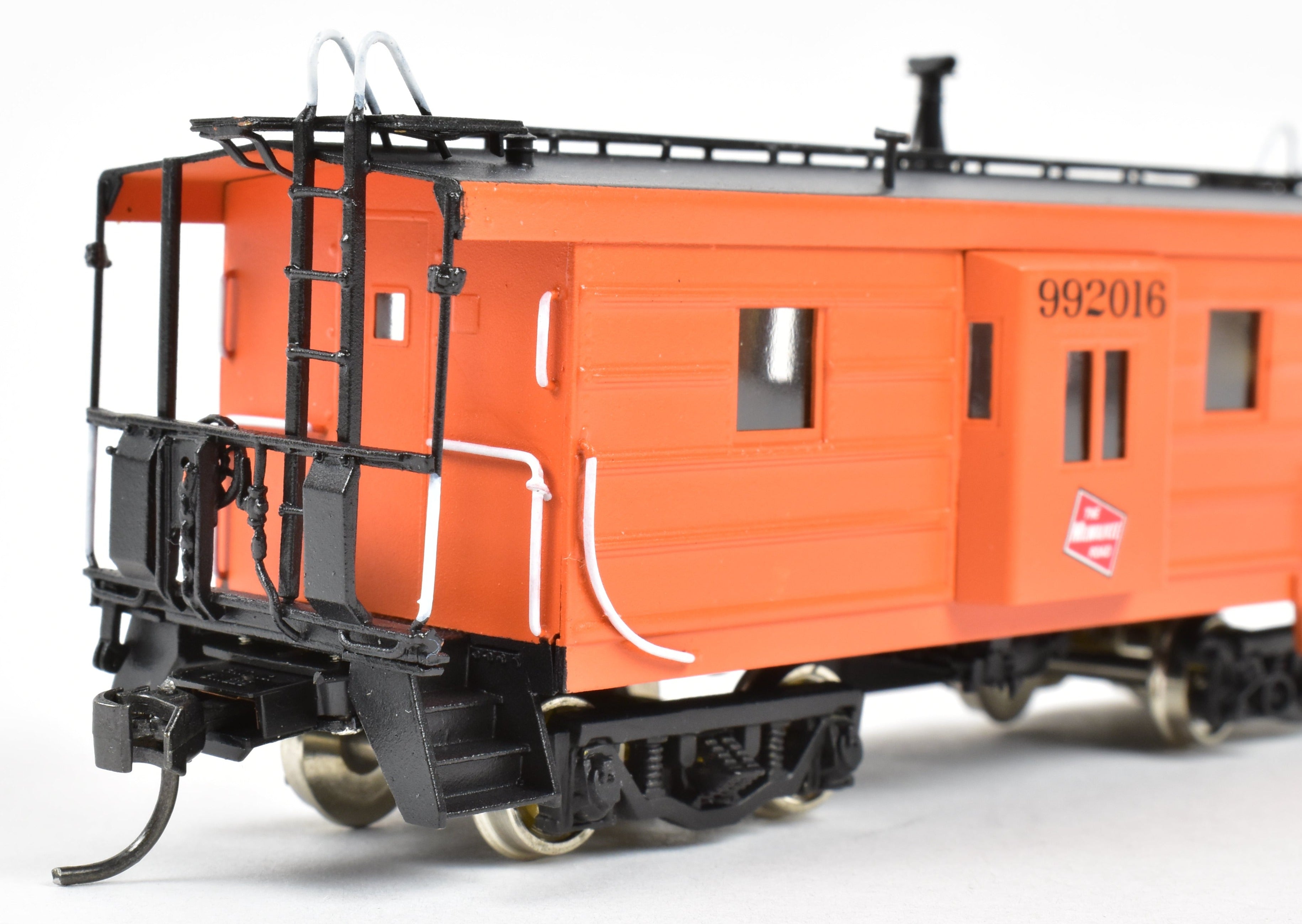 HO Scale Brass Model of Overland Models, Inc. Milwaukee Road Bay Window Caboose with Drop Center Trucks, CP No. 992016