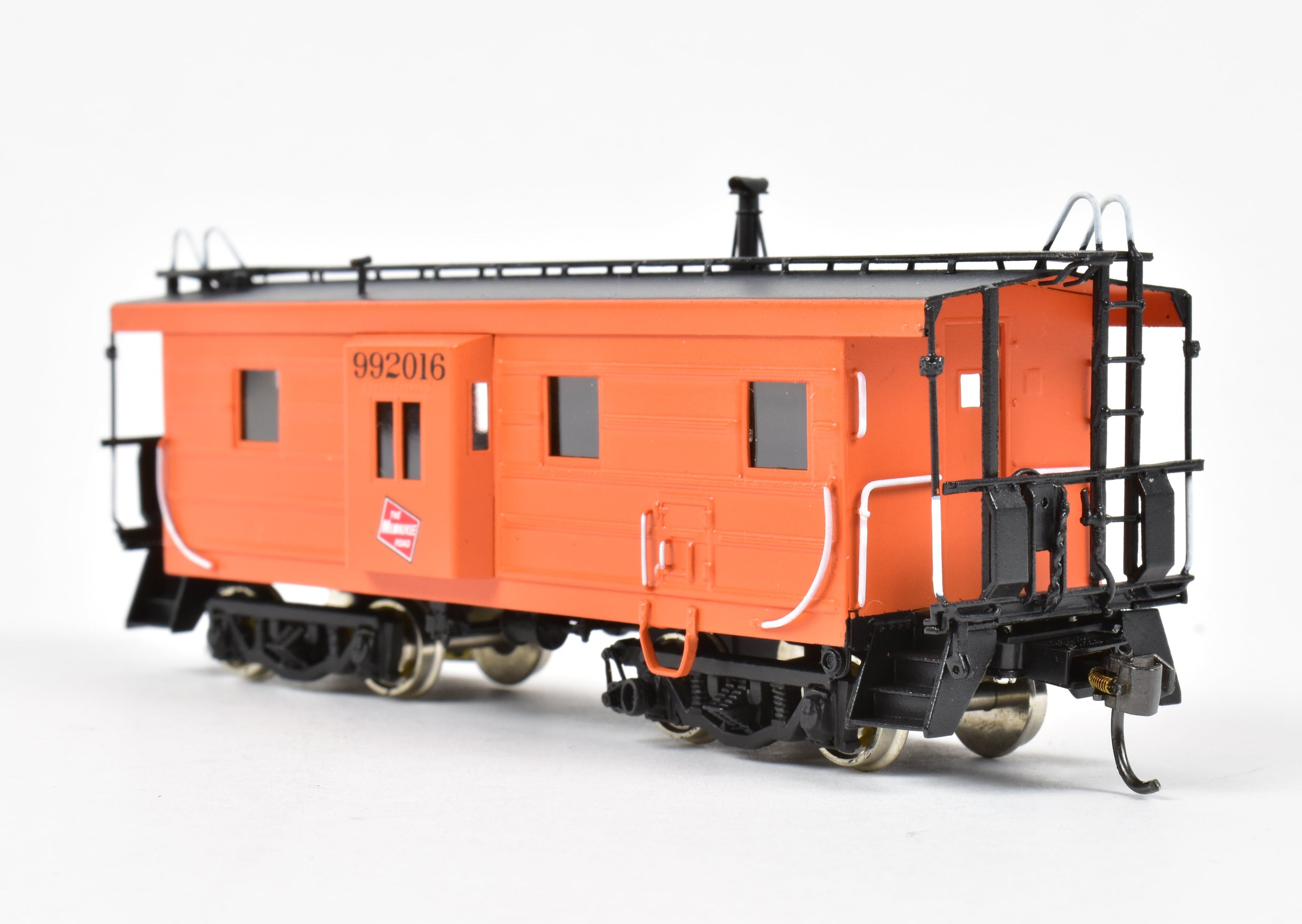 HO Scale Brass Model of Overland Models, Inc. Milwaukee Road Bay Window Caboose with Drop Center Trucks, CP No. 992016